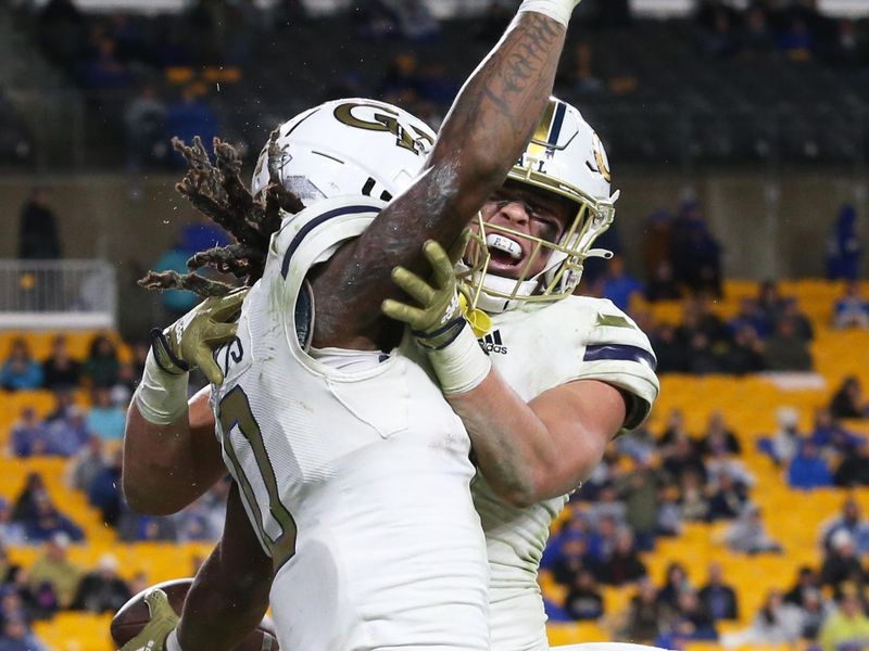 Oct 1, 2022; Pittsburgh, Pennsylvania, USA;  Georgia Tech Yellow Jackets wide receiver E.J. Jenkins (0) celebrates with tight end Dylan Leonard (right) after scoring a touchdown against the Pittsburgh Panthers during the fourth quarter at Acrisure Stadium. Georgia Tech won 26-21.Mandatory Credit: Charles LeClaire-USA TODAY Sports