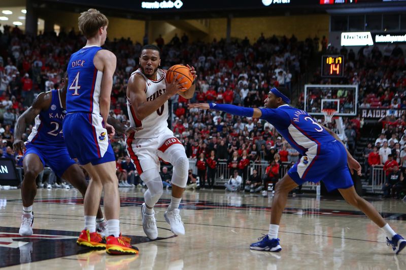 Jan 3, 2023; Lubbock, Texas, USA;  Texas Tech Red Raiders forward Kevin Obanor (0) drives into the lane against Kansas Jayhawks guard Gradey Dick (4) in the second half at United Supermarkets Arena. Mandatory Credit: Michael C. Johnson-USA TODAY Sports