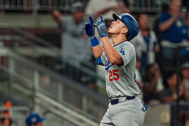 Sep 15, 2024; Cumberland, Georgia, USA; Los Angeles Dodgers shortstop Tommy Edman (25) reacts after hitting a home run against the Atlanta Braves during the ninth inning at Truist Park. Mandatory Credit: Dale Zanine-Imagn Images