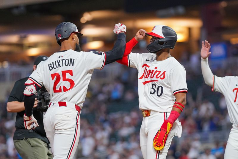 May 6, 2025; Minneapolis, Minnesota, USA; Minnesota Twins outfielder Byron Buxton (25) celebrates his home run with outfielder Willi Castro (50) against the Baltimore Orioles in the seventh inning at Target Field. Mandatory Credit: Brad Rempel-Imagn Images