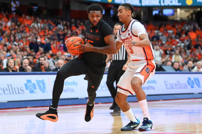 Jan 20, 2024; Syracuse, New York, USA; Miami (Fl) Hurricanes guard Wooga Poplar (5) drives to the basket as Syracuse Orange guard Judah Mintz (3) defends during the first half at the JMA Wireless Dome. Mandatory Credit: Rich Barnes-USA TODAY Sports