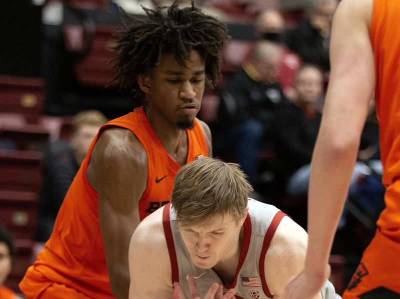 Jan 19, 2023; Stanford, California, USA; Oregon State Beavers forward Glenn Taylor Jr. (left) knocks the ball out of the hands of Stanford Cardinal guard Michael Jones (13) during the first half at Maples Pavilion. Mandatory Credit: D. Ross Cameron-USA TODAY Sports