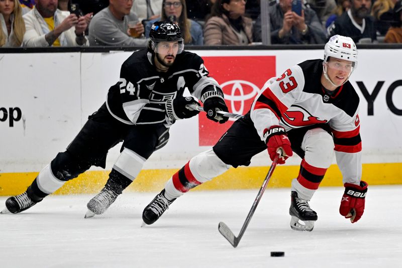 Mar 3, 2024; Los Angeles, California, USA; New Jersey Devils left wing Jesper Bratt (63) keeps the puck away from Los Angeles Kings center Phillip Danault (24) in the second period at Crypto.com Arena. Mandatory Credit: Jayne Kamin-Oncea-USA TODAY Sports