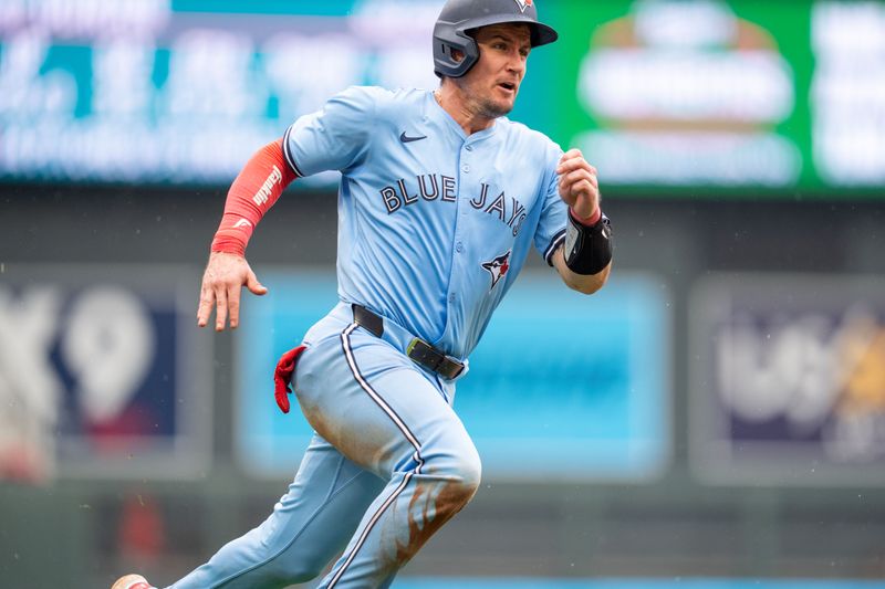 Jun 7, 2025; Minneapolis, Minnesota, USA; Toronto Blue Jays catcher Tyler Heineman (55) runs to home plate to score on a hit by first base Vladimir Guerrero Jr. (27) off a pitch by Minnesota Twins pitcher Jhoan Duran (59) in the ninth inning at Target Field. Mandatory Credit: Matt Blewett-Imagn Images