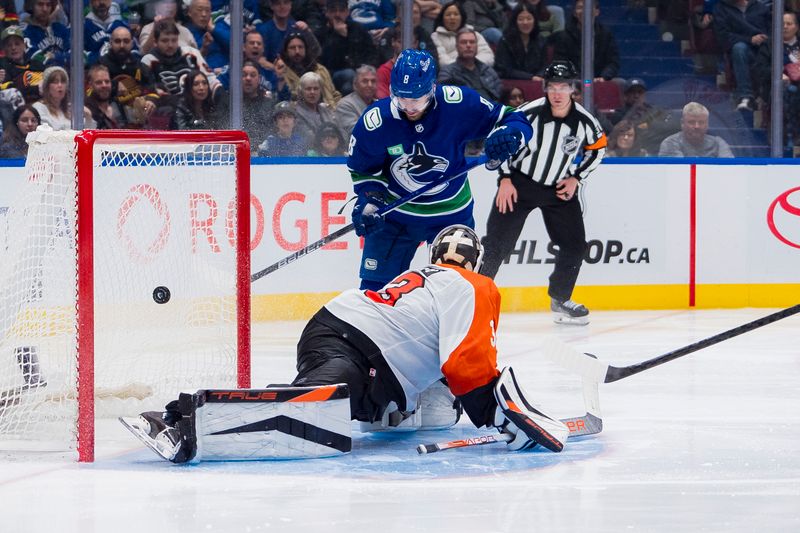 Dec 28, 2023; Vancouver, British Columbia, CAN; Vancouver Canucks forward Conor Garland (8) watches the shot from forward Teddy Blueger (53) beat Philadelphia Flyers goalie Samuel Ersson (33) in the third period at Rogers Arena. Flyers won 4-1. Mandatory Credit: Bob Frid-USA TODAY Sports