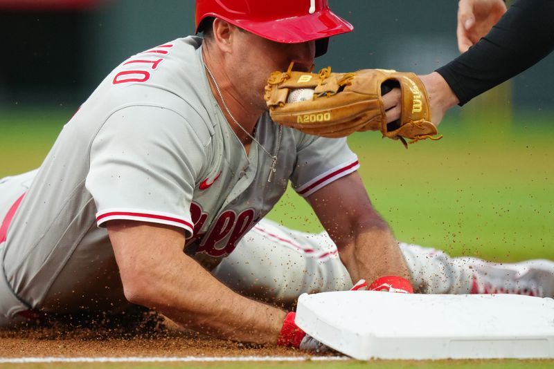 May 12, 2023; Denver, Colorado, USA; Philadelphia Phillies catcher J.T. Realmuto (10) is tagged out by Colorado Rockies third baseman Ryan McMahon (24) in the fifth inning at Coors Field. Mandatory Credit: Ron Chenoy-USA TODAY Sports