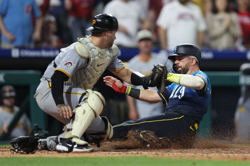 May 16, 2025; Philadelphia, Pennsylvania, USA; Philadelphia Phillies outfielder Kyle Schwarber (12) scores past Pittsburgh Pirates catcher Joey Bart (14) during the seventh inning at Citizens Bank Park. Mandatory Credit: Bill Streicher-Imagn Images