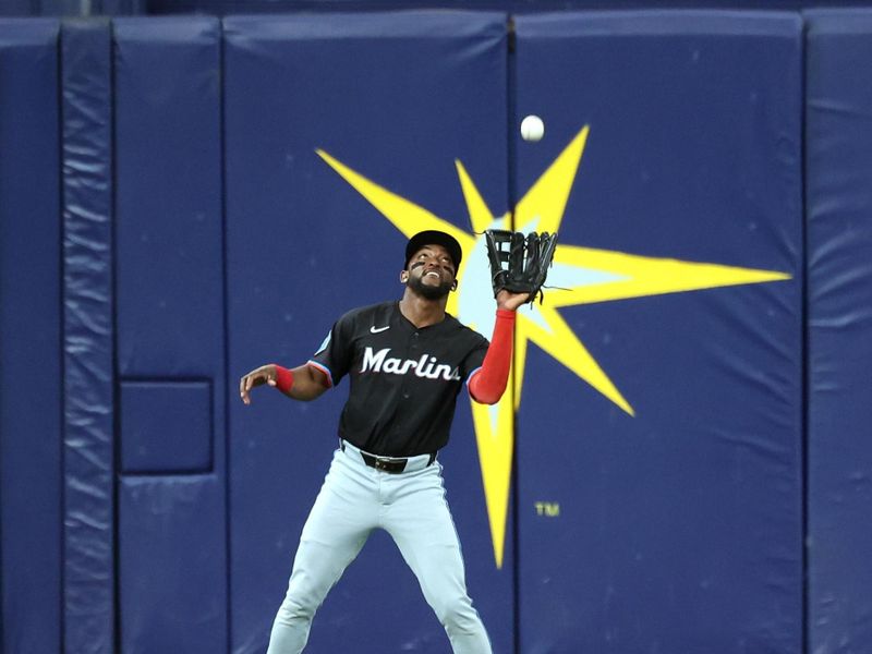 Jul 30, 2024; St. Petersburg, Florida, USA;  Miami Marlins shortstop Vidal Brujan (17) catches a fly ball against the Tampa Bay Rays during the first inning at Tropicana Field. Mandatory Credit: Kim Klement Neitzel-USA TODAY Sports