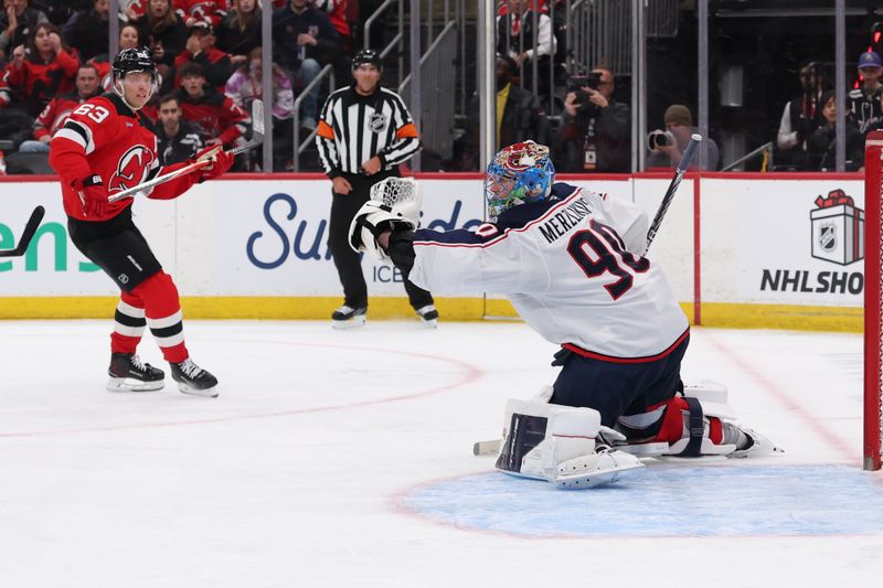 Dec 1, 2025; Newark, New Jersey, USA; Columbus Blue Jackets goaltender Elvis Merzlikins (90) makes a save on New Jersey Devils left wing Jesper Bratt (63) during the second period at Prudential Center. Mandatory Credit: Ed Mulholland-Imagn Images