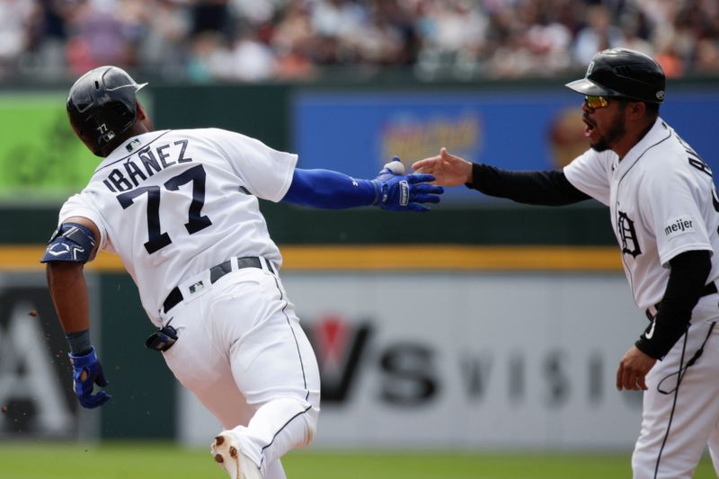 Jul 23, 2023; Detroit, Michigan, USA; Detroit Tigers infielder Andy Ib    ez (77) high fives first base coach Alfredo Amezaga (99) after hitting a home run during the game against the San Diego Padres at Comerica Park. Mandatory Credit: Brian Bradshaw Sevald-USA TODAY Sports