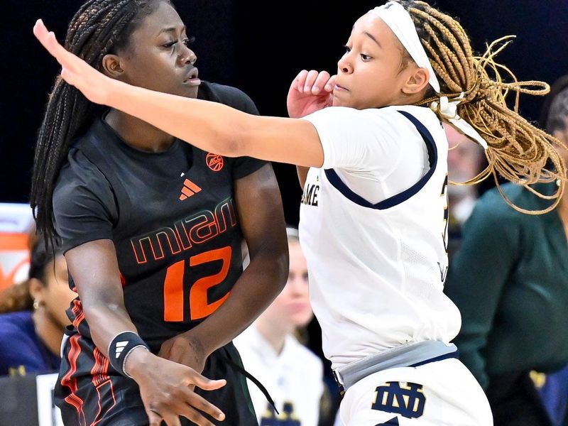 Jan 14, 2024; South Bend, Indiana, USA; Miami Hurricanes guard Ja'Leah Williams (12) passes the ball as Notre Dame Fighting Irish guard Hannah Hidalgo (3) defends in the first half at the Purcell Pavilion. Mandatory Credit: Matt Cashore-USA TODAY Sports