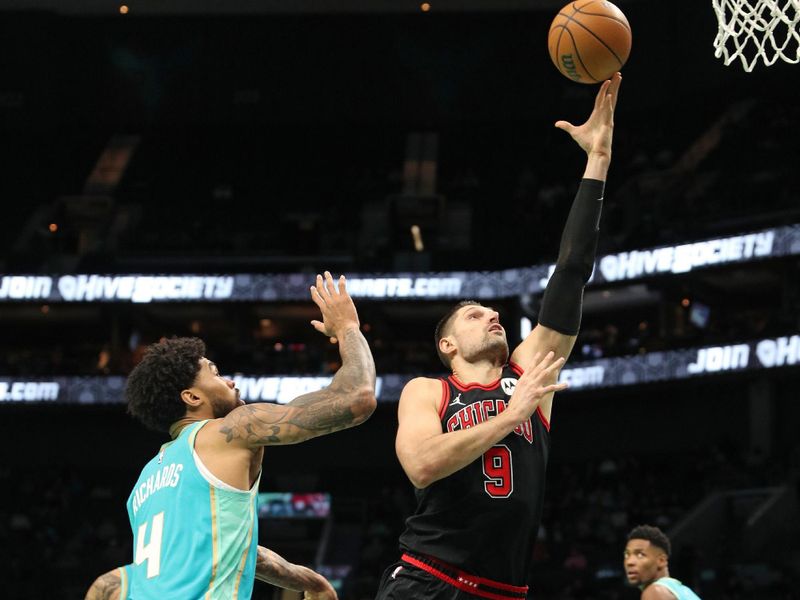 CHARLOTTE, NC - JANUARY 31: Nikola Vucevic #9 of the Chicago Bulls shoots the ball during the game against the Charlotte Hornets  on January 31, 2024 at Spectrum Center in Charlotte, North Carolina. NOTE TO USER: User expressly acknowledges and agrees that, by downloading and or using this photograph, User is consenting to the terms and conditions of the Getty Images License Agreement.  Mandatory Copyright Notice:  Copyright 2024 NBAE (Photo by Brock Williams-Smith/NBAE via Getty Images)