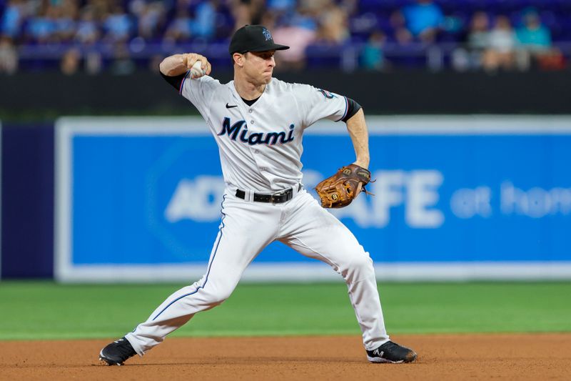 Jun 4, 2023; Miami, Florida, USA; Miami Marlins shortstop Joey Wendle (18) throws to first baseman Yuli Gurriel (not pictured) to retire Oakland Athletics center fielder Esteury Ruiz (not pictured) during the first inning at loanDepot Park. Mandatory Credit: Sam Navarro-USA TODAY Sports