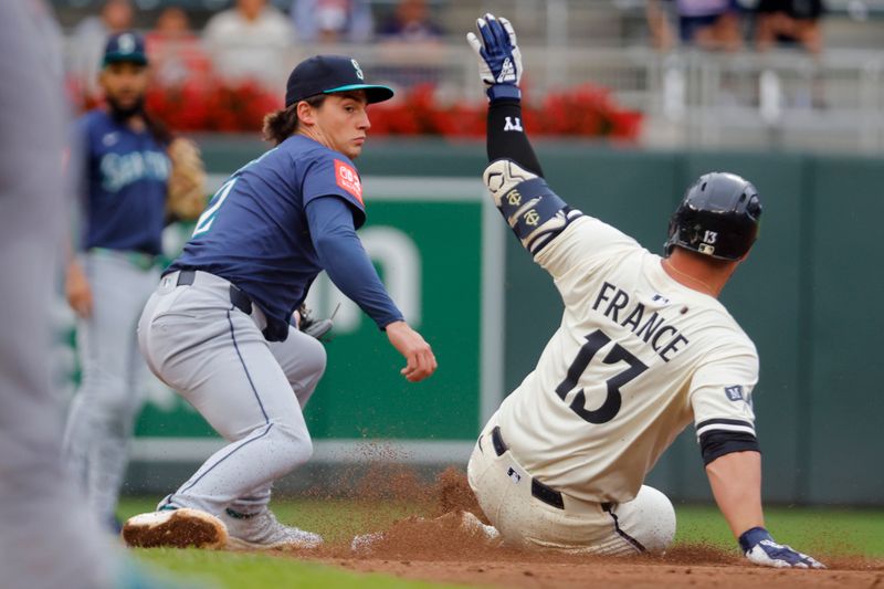 Jun 26, 2025; Minneapolis, Minnesota, USA; Minnesota Twins first baseman Ty France (13) sliced into second base with a double as Seattle Mariners second baseman Cole Young (2) awaits the throw in the sixth inning at Target Field. Mandatory Credit: Bruce Kluckhohn-Imagn Images