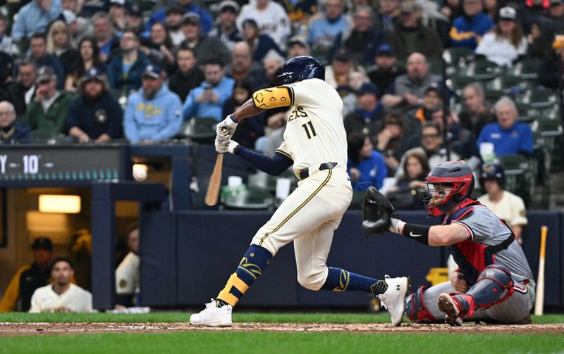 Apr 3, 2024; Milwaukee, Wisconsin, USA; Milwaukee Brewers right fielder Jackson Chourio (11) hits his first Major League home run against the Minnesota Twins in the fifth inning at American Family Field. Mandatory Credit: Michael McLoone-USA TODAY Sports