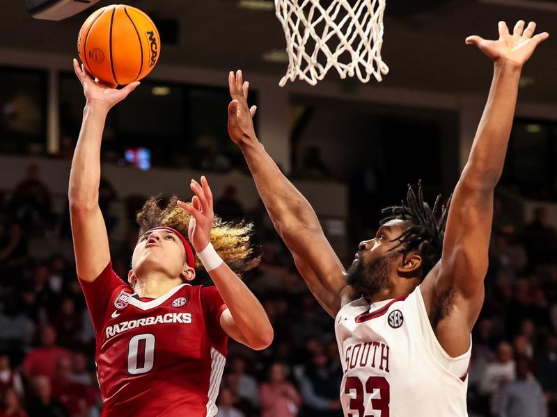 Feb 4, 2023; Columbia, South Carolina, USA; Arkansas Razorbacks guard Anthony Black (0) shoots over South Carolina Gamecocks forward Josh Gray (33) in the second half at Colonial Life Arena. Mandatory Credit: Jeff Blake-USA TODAY Sports