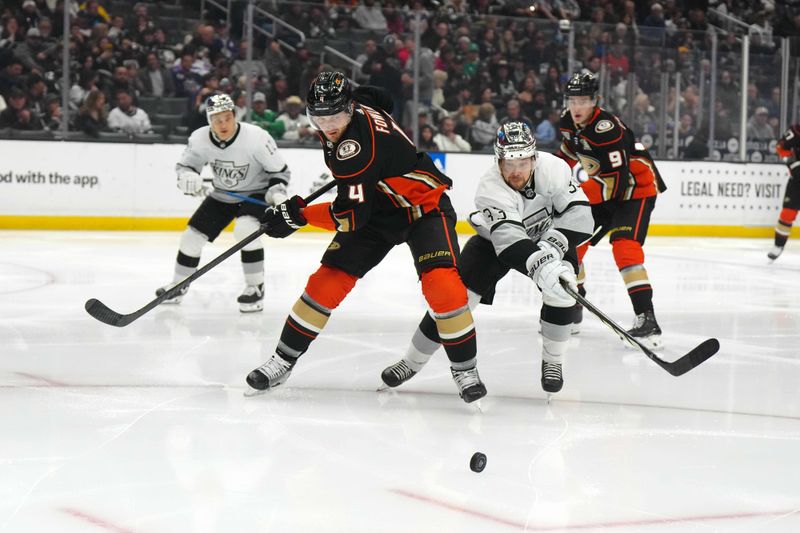 Apr 13, 2024; Los Angeles, California, USA; Anaheim Ducks defenseman Cam Fowler (4) and LA Kings right wing Viktor Arvidsson (33) battle for the puck in the second period at Crypto.com Arena. Mandatory Credit: Kirby Lee-USA TODAY Sports