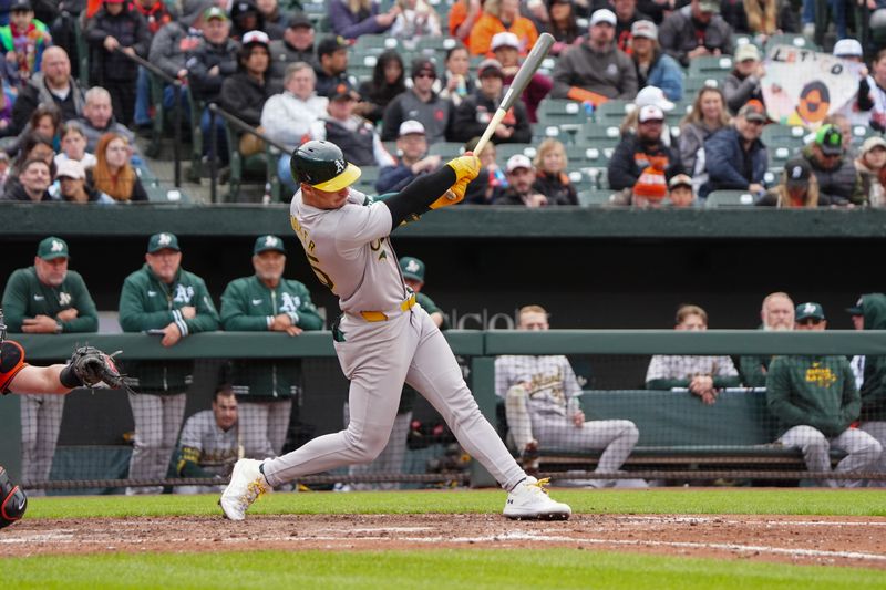 Apr 27, 2024; Baltimore, Maryland, USA; Oakland Athletics designated hitter Brent Rooker (25) hits an infield single against the Baltimore Orioles during the seventh inning at Oriole Park at Camden Yards. Mandatory Credit: Gregory Fisher-USA TODAY Sports