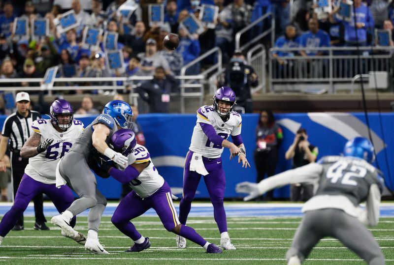 Minnesota Vikings quarterback Nick Mullens (12) passes the ball against the Detroit Lions during the first half of an NFL football game Sunday, Jan. 7, 2024, in Detroit. (AP Photo/Duane Burleson)