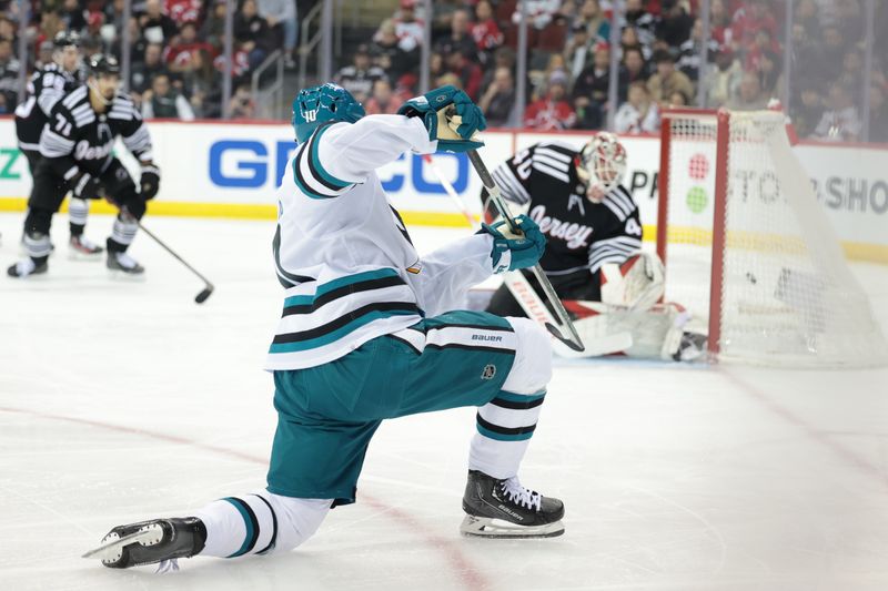 Dec 1, 2023; Newark, New Jersey, USA; San Jose Sharks left wing Anthony Duclair (10) scores a goal past New Jersey Devils goaltender Akira Schmid (40) during the second period at Prudential Center. Mandatory Credit: Vincent Carchietta-USA TODAY Sports