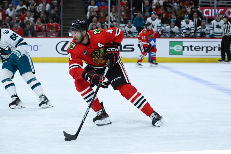 Jan 16, 2024; Chicago, Illinois, USA; Chicago Blackhawks defenseman Seth Jones (4) moves the puck against there San Jose Sharks during the first period at United Center. Mandatory Credit: Matt Marton-USA TODAY Sports