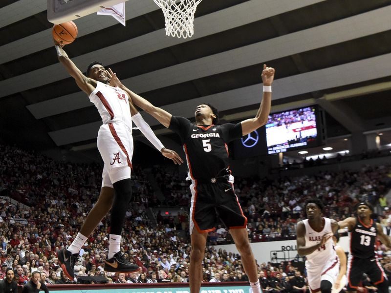 Feb 18, 2023; Tuscaloosa, Alabama, USA;  Alabama forward Brandon Miller (24) reaches back and grabs a pass with one hand and scores over Georgia center Frank Anselem (5) at Coleman Coliseum. Mandatory Credit: Gary Cosby Jr.-USA TODAY Sports