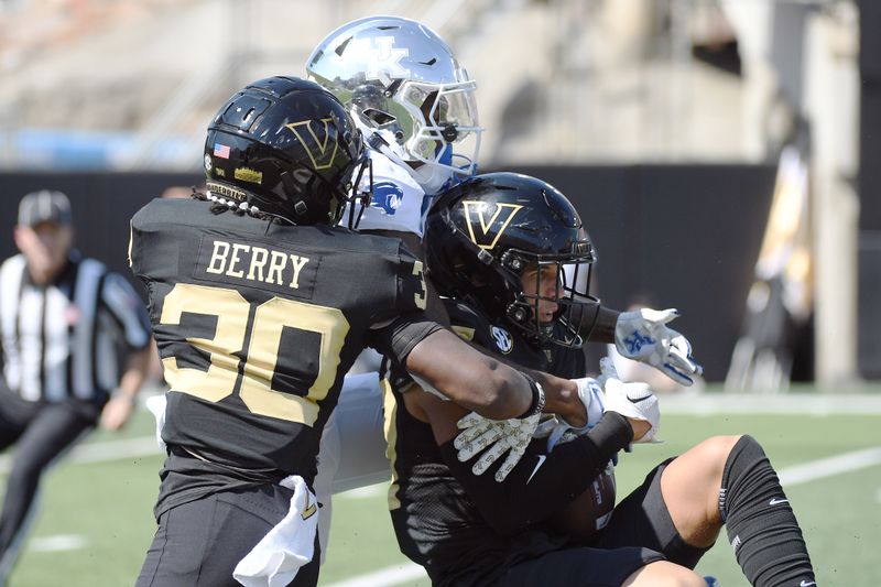 Sep 23, 2023; Nashville, Tennessee, USA; Vanderbilt Commodores safety John Howse IV (27) intercepts a pass intended for Kentucky Wildcats wide receiver Barion Brown (7) during the first half at FirstBank Stadium. Mandatory Credit: Christopher Hanewinckel-USA TODAY Sports