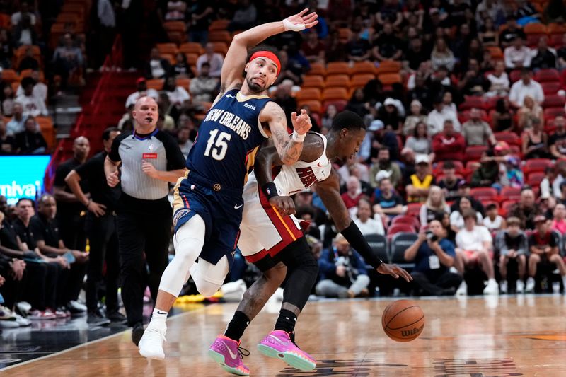 MIAMI, FLORIDA - MARCH 22: Terry Rozier #2 of the Miami Heat dribbles the ball against Jose Alvarado #15 of the New Orleans Pelicans during the first quarter at Kaseya Center on March 22, 2024 in Miami, Florida. NOTE TO USER: User expressly acknowledges and agrees that, by downloading and or using this photograph, User is consenting to the terms and conditions of the Getty Images License Agreement. (Photo by Rich Storry/Getty Images)