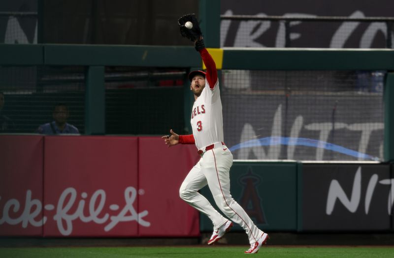 May 2, 2025; Anaheim, California, USA; Los Angeles Angels outfielder Taylor Ward (3) makes a catch during the fifth inning against the Detroit Tigers at Angel Stadium. Mandatory Credit: Jason Parkhurst-Imagn Images