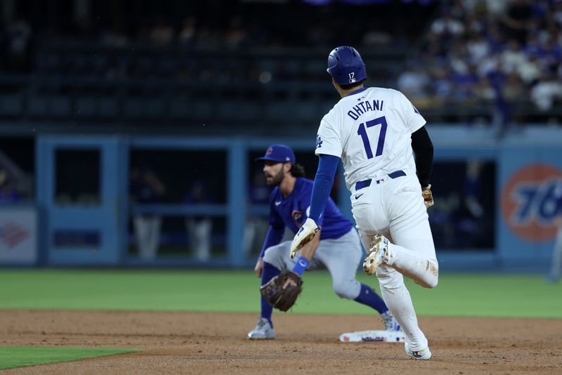 Sep 11, 2024; Los Angeles, California, USA;  Los Angeles Dodgers designated hitter Shohei Ohtani (17) steals second base during the second inning against the Chicago Cubs at Dodger Stadium. Mandatory Credit: Kiyoshi Mio-Imagn Images