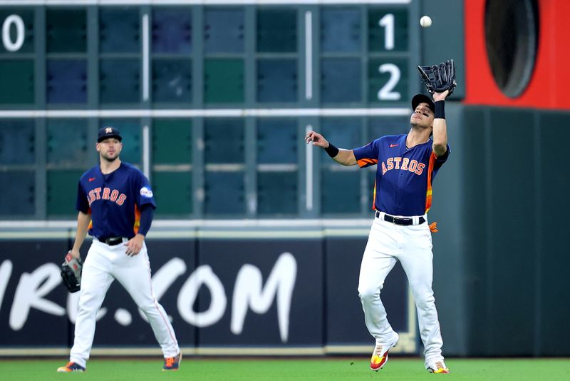 Jul 30, 2023; Houston, Texas, USA; Houston Astros center fielder Mauricio Dubon (14) catches a fly ball for an out against the Tampa Bay Rays during the fourth inning at Minute Maid Park. Mandatory Credit: Erik Williams-USA TODAY Sports