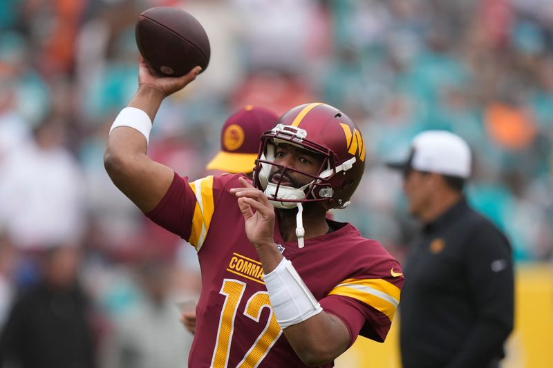 Washington Commanders quarterback Jacoby Brissett (12) throws the ball during warmups of an NFL football game against the Miami Dolphins Sunday, Dec. 3, 2023, in Landover, Md. (AP Photo/Mark Schiefelbein)