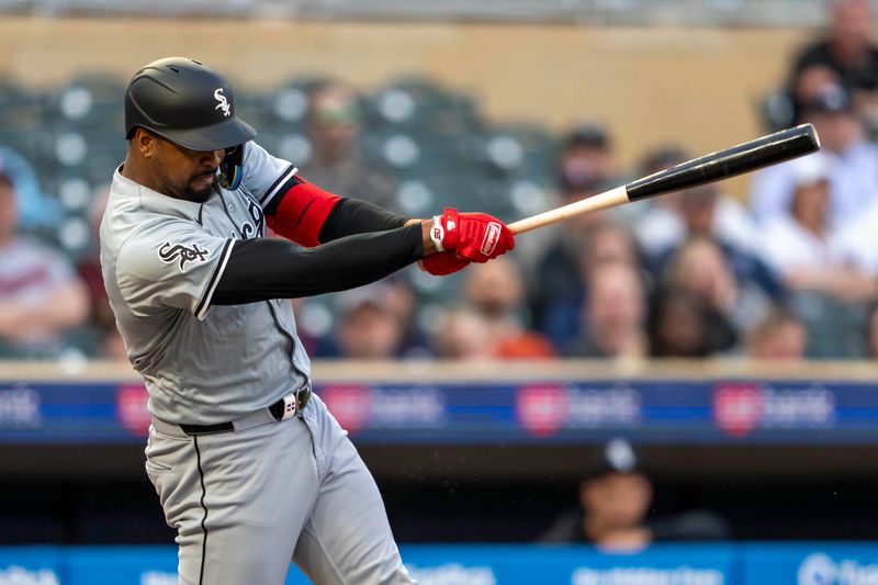 Apr 22, 2024; Minneapolis, Minnesota, USA; Chicago White Sox designated hitter Eloy Jiménez (74) hits a single against the Minnesota Twins in the fourth inning at Target Field. Mandatory Credit: Jesse Johnson-USA TODAY Sports