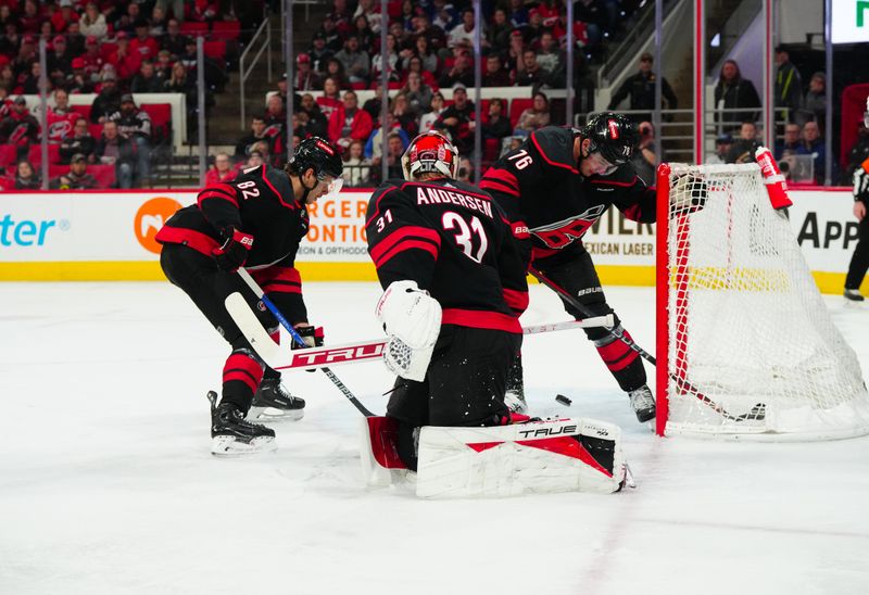 Mar 24, 2024; Raleigh, North Carolina, USA;  Carolina Hurricanes defenseman Brady Skjei (76) clears the puck away from the net against the Toronto Maple Leafs during the second period at PNC Arena. Mandatory Credit: James Guillory-USA TODAY Sports