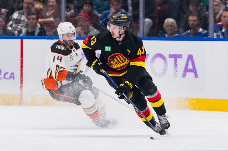 Nov 28, 2023; Vancouver, British Columbia, CAN; Anaheim Ducks forward Adam Henrique (14) defends against Vancouver Canucks defenseman Quinn Hughes (43) in the third period at Rogers Arena. Vancouver won 3-1. Mandatory Credit: Bob Frid-USA TODAY Sports