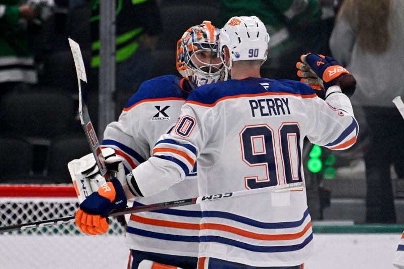 May 23, 2025; Dallas, Texas, USA; Edmonton Oilers right wing Corey Perry (90) and goaltender Stuart Skinner (74)  react after defeating the Dallas Stars in game two of the Western Conference Final of the 2025 Stanley Cup Playoffs at American Airlines Center. Mandatory Credit: Jerome Miron-Imagn Images