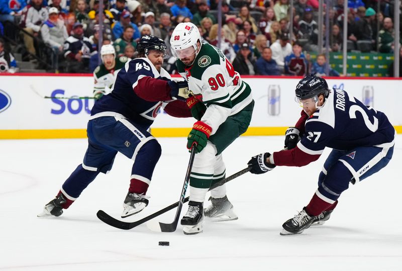 Feb 28, 2025; Denver, Colorado, USA; Colorado Avalanche defenseman Samuel Girard (49) and left wing Jonathan Drouin (27) defend on Minnesota Wild center Marcus Johansson (90) in the third period at Ball Arena. Mandatory Credit: Ron Chenoy-Imagn Images