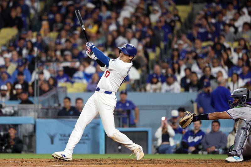 Jun 1, 2024; Los Angeles, California, USA;  Los Angeles Dodgers designated hitter Shohei Ohtani (17) hits a single during the seventh inning against the Colorado Rockies at Dodger Stadium. Mandatory Credit: Kiyoshi Mio-USA TODAY Sports