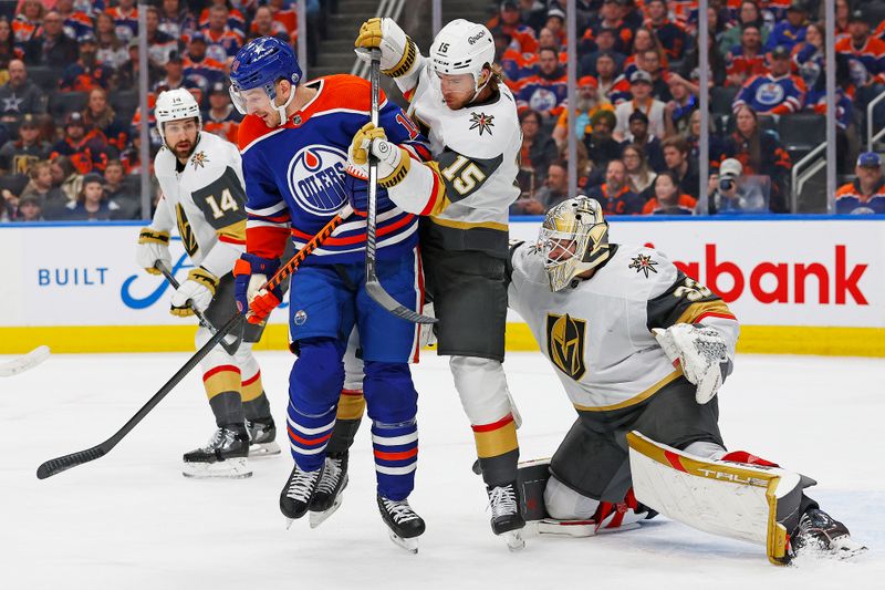 Apr 10, 2024; Edmonton, Alberta, CAN; Edmonton Oilers forward Zach Hyman (18) tries to deflect a shot on Vegas Golden Knights goaltender Adin Hill (33) during the first period at Rogers Place. Mandatory Credit: Perry Nelson-USA TODAY Sports