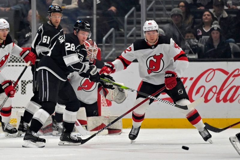 Mar 3, 2024; Los Angeles, California, USA; Los Angeles Kings center Jaret Anderson-Dolan (28) and New Jersey Devils center Curtis Lazar (42) go for the puck in the first period at Crypto.com Arena. Mandatory Credit: Jayne Kamin-Oncea-USA TODAY Sports