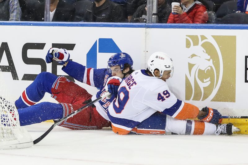 Sep 26, 2023; New York, New York, USA;  New York Rangers center Matt Rempe (73) collides with New York Islanders defenseman Isaiah George (49) in the first period at Madison Square Garden. Mandatory Credit: Wendell Cruz-USA TODAY Sports