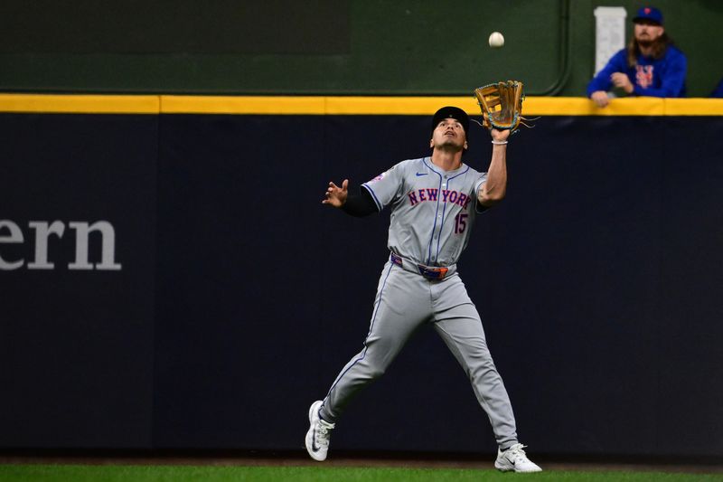 Oct 1, 2024; Milwaukee, Wisconsin, USA; New York Mets outfielder Tyrone Taylor (15) makes a catch against the Milwaukee Brewers during the sixth inning in game one of the Wildcard round for the 2024 MLB Playoffs at American Family Field. Mandatory Credit: Benny Sieu-Imagn Images