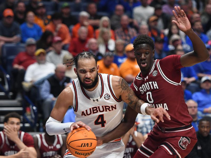 Mar 15, 2024; Nashville, TN, USA; Auburn Tigers forward Johni Broome (4) drives baseline against guard Ebrima Dibba (0) during the first half at Bridgestone Arena. Mandatory Credit: Christopher Hanewinckel-USA TODAY Sports