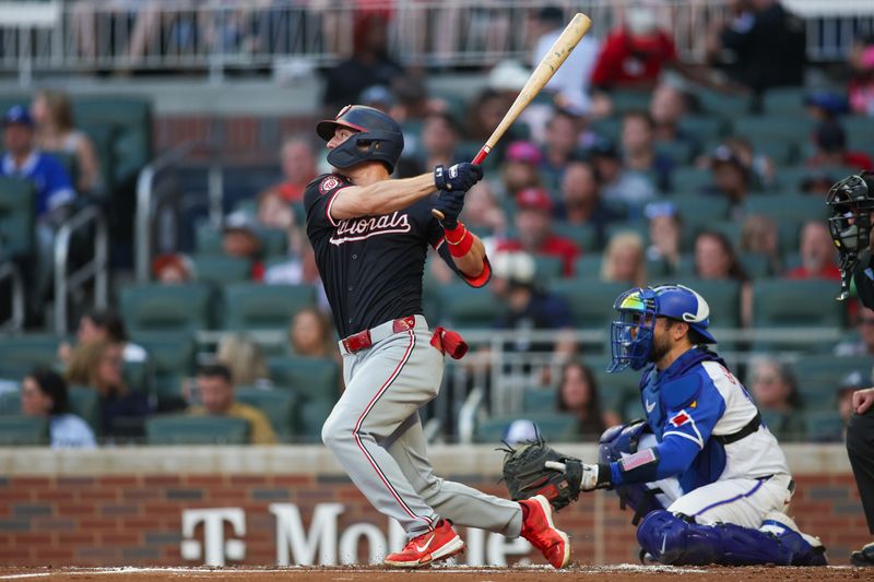 Aug 24, 2024; Atlanta, Georgia, USA; Washington Nationals center fielder Jacob Young (30) hits a single against the Atlanta Braves in the second inning at Truist Park. Mandatory Credit: Brett Davis-USA TODAY Sports