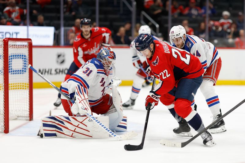 Dec 23, 2025; Washington, District of Columbia, USA; Washington Capitals right wing Brandon Duhaime (22) attempts a shot on New York Rangers goaltender Igor Shesterkin (31) as Rangers defenseman Carson Soucy (24) defends during the third period at Capital One Arena. Mandatory Credit: Geoff Burke-Imagn Images