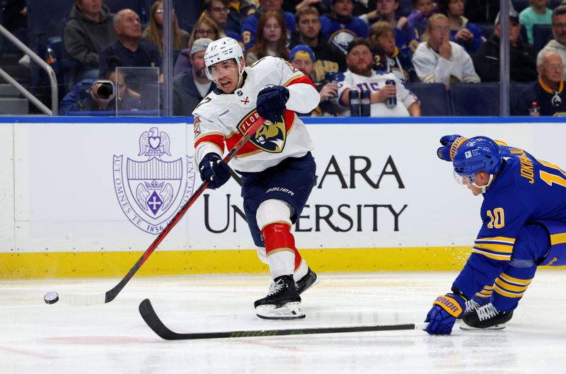 Oct 12, 2024; Buffalo, New York, USA;  Buffalo Sabres defenseman Henri Jokiharju (10) tries to block a shot by Florida Panthers center Evan Rodrigues (17) during the third period at KeyBank Center. Mandatory Credit: Timothy T. Ludwig-Imagn Images