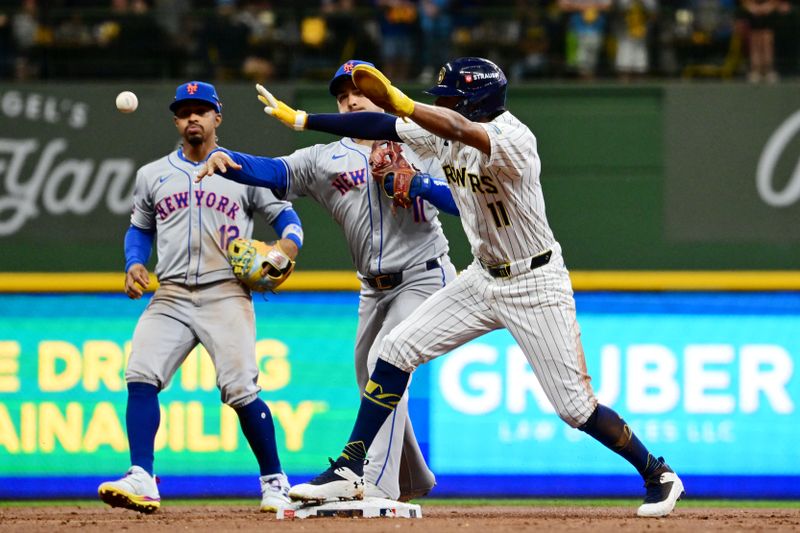 Oct 3, 2024; Milwaukee, Wisconsin, USA; New York Mets second baseman Jose Iglesias (11) throws out Milwaukee Brewers designated hitter William Contreras (not pictured) as outfielder Jackson Chourio (11) is safe at second in the first inning during game three of the Wildcard round for the 2024 MLB Playoffs at American Family Field. Mandatory Credit: Benny Sieu-Imagn Images