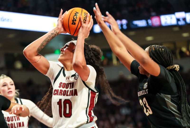 Jan 28, 2024; Columbia, South Carolina, USA; South Carolina Gamecocks center Kamilla Cardoso (10) drives past Vanderbilt Commodores guard Iyana Moore (23) in the first half at Colonial Life Arena. Mandatory Credit: Jeff Blake-USA TODAY Sports