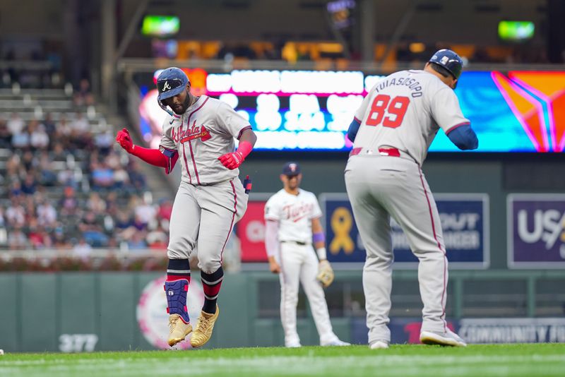 Aug 27, 2024; Minneapolis, Minnesota, USA; Atlanta Braves outfielder Michael Harris II (23) celebrates his home run with third base coach Matt Tuiasosopo (89) against the Minnesota Twins in the second inning at Target Field. Mandatory Credit: Brad Rempel-USA TODAY Sports