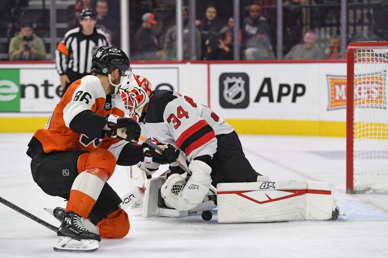 Jan 27, 2025; Philadelphia, Pennsylvania, USA; Philadelphia Flyers left wing Joel Farabee (86) scores a goal against ]New Jersey Devils goaltender Jake Allen (34) during the first period at Wells Fargo Center. Mandatory Credit: Eric Hartline-Imagn Images